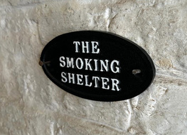 the smoking shelter sign